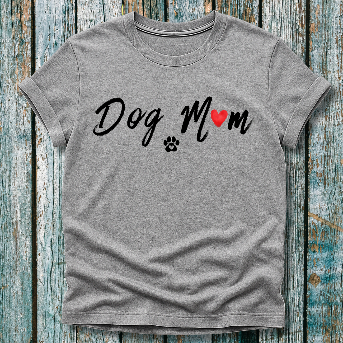 Gray t-shirt with 'Dog Mom' 'Dog Mum' text and heart and paw graphic on a wooden surface