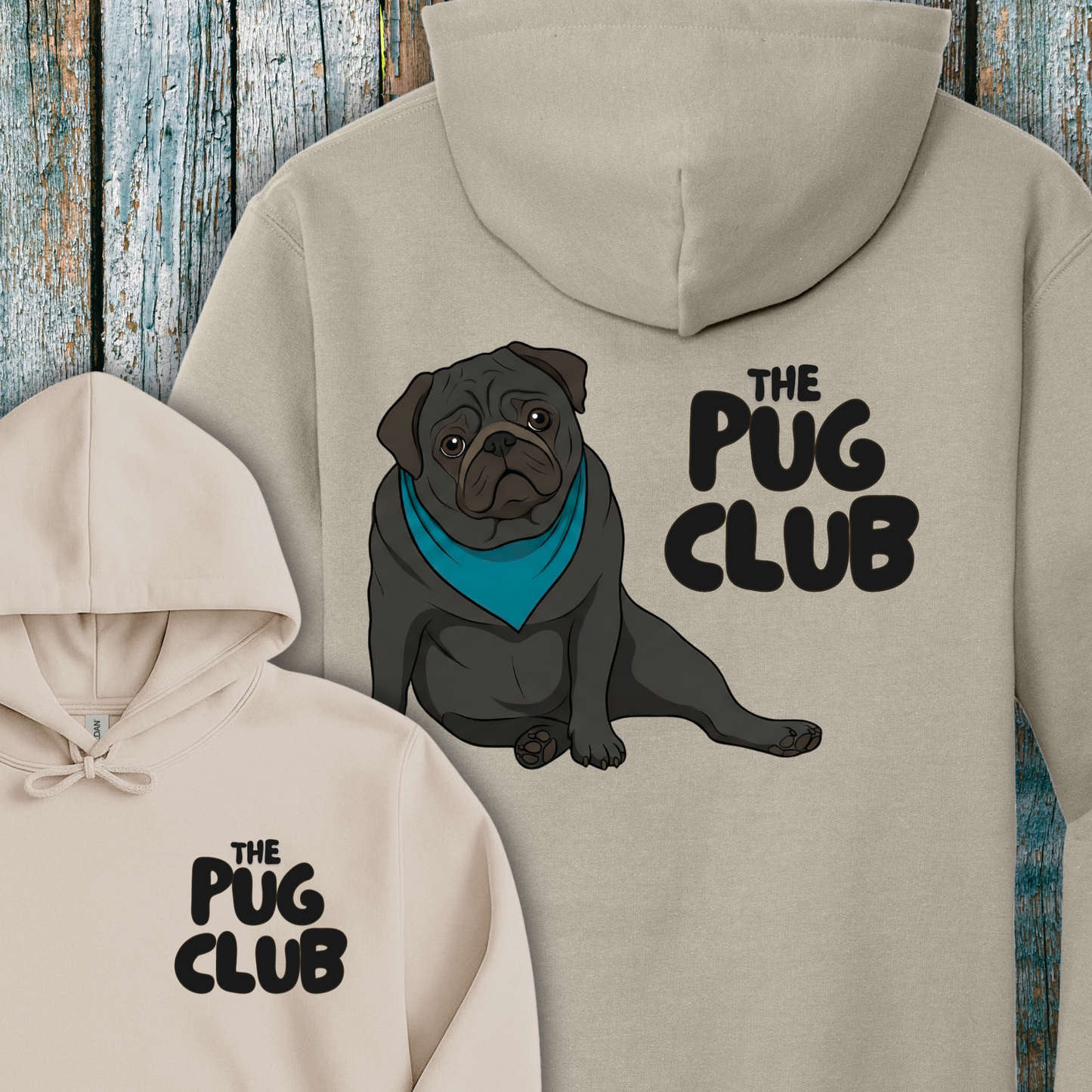 Beige hoodie with a pug illustration and 'The Pug Club' text on a wooden background