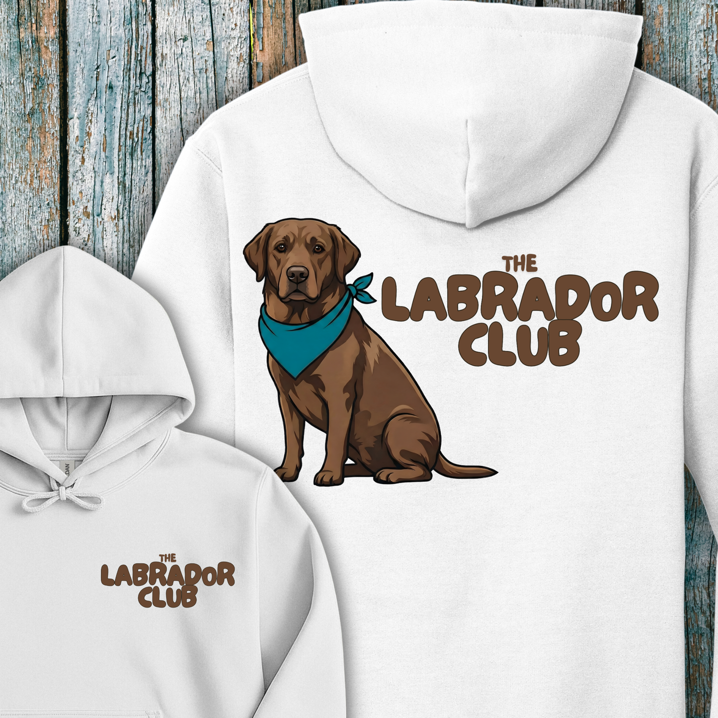 White hoodie with a chocolate labrador illustration and 'The Labrador Club' text on a wooden background