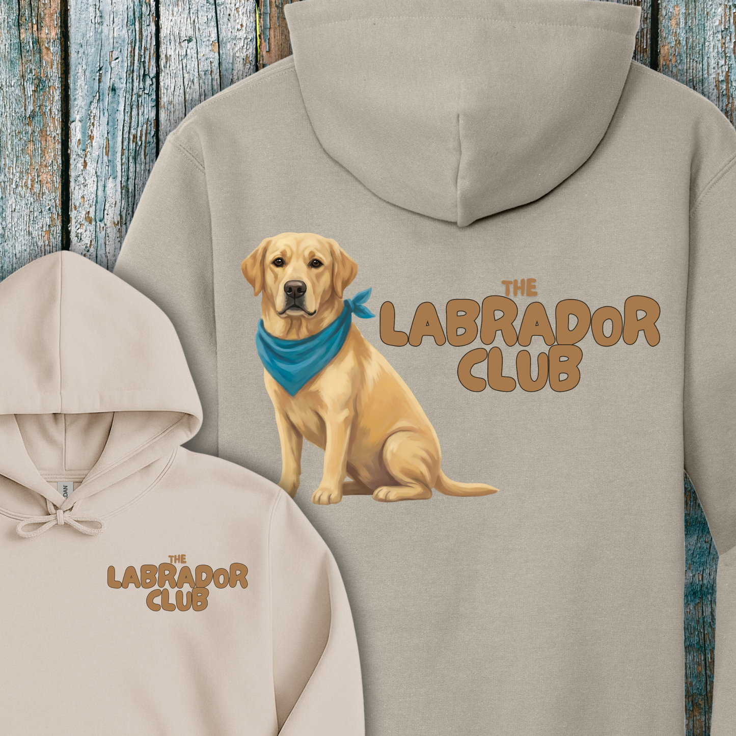 Beige hoodie with a Golden Labrador illustration and 'The Labrador Club' text on a wooden background