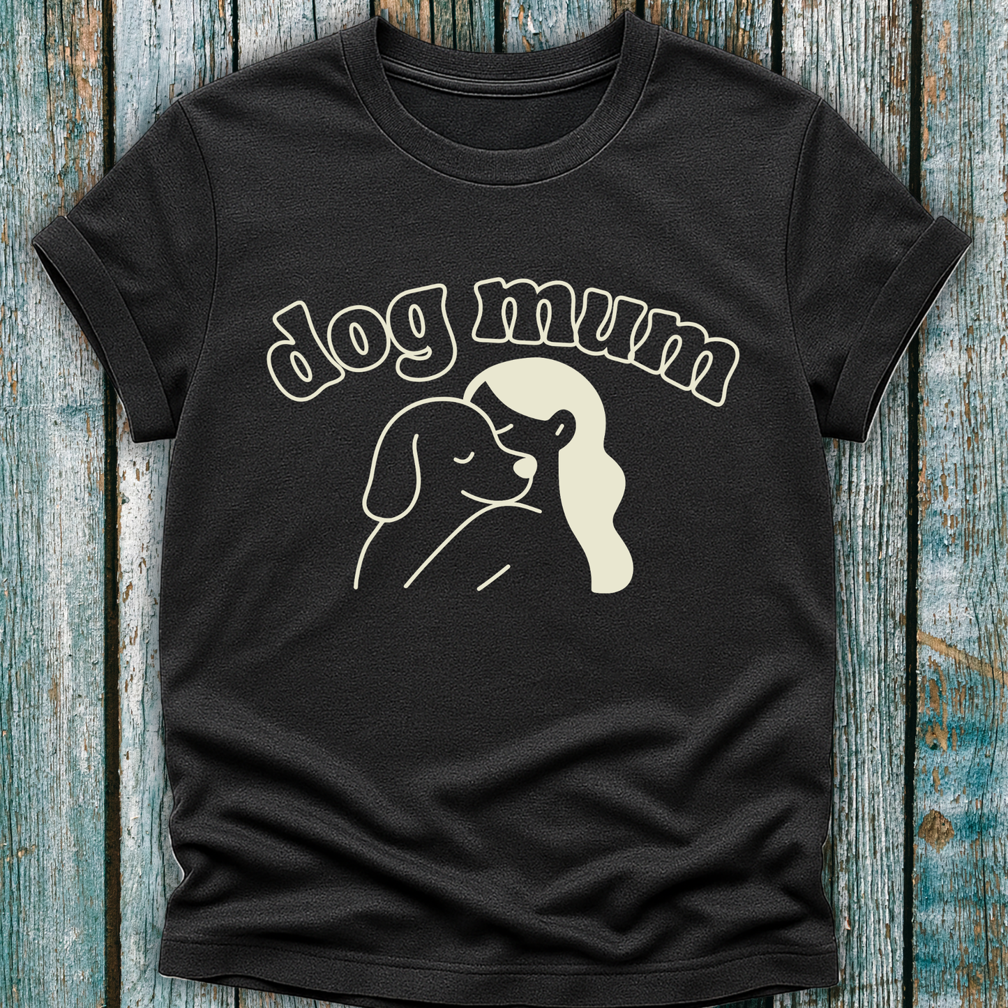 Black t-shirt with 'dog mum' text and graphic on a wooden surface