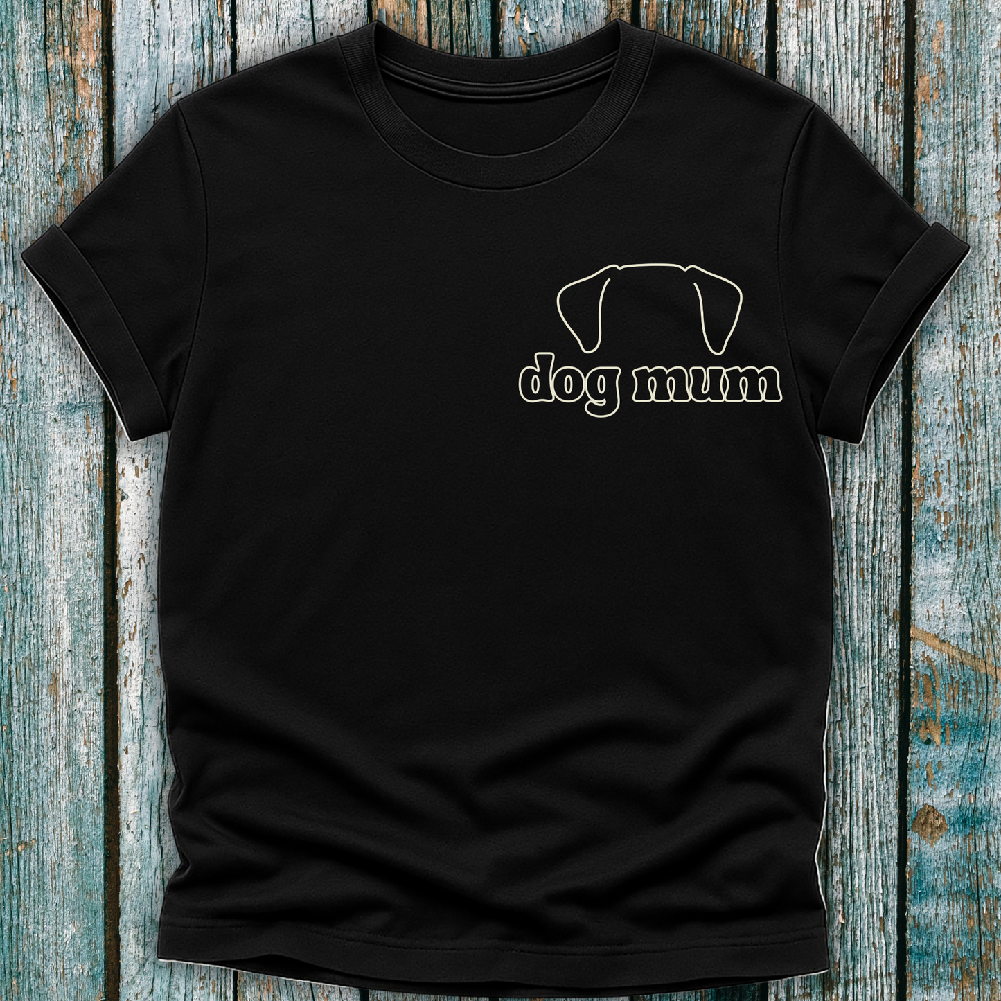 Black t-shirt with 'dog mum' text and dog graphic on a wooden surface