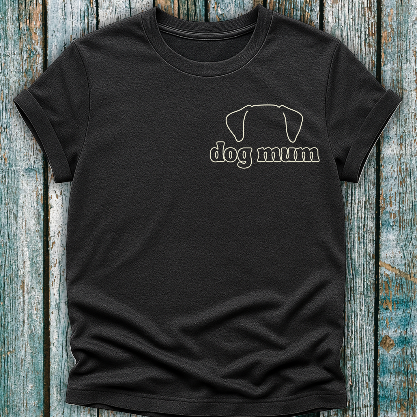 Black t-shirt with 'dog mum' text and dog graphic on a wooden surface