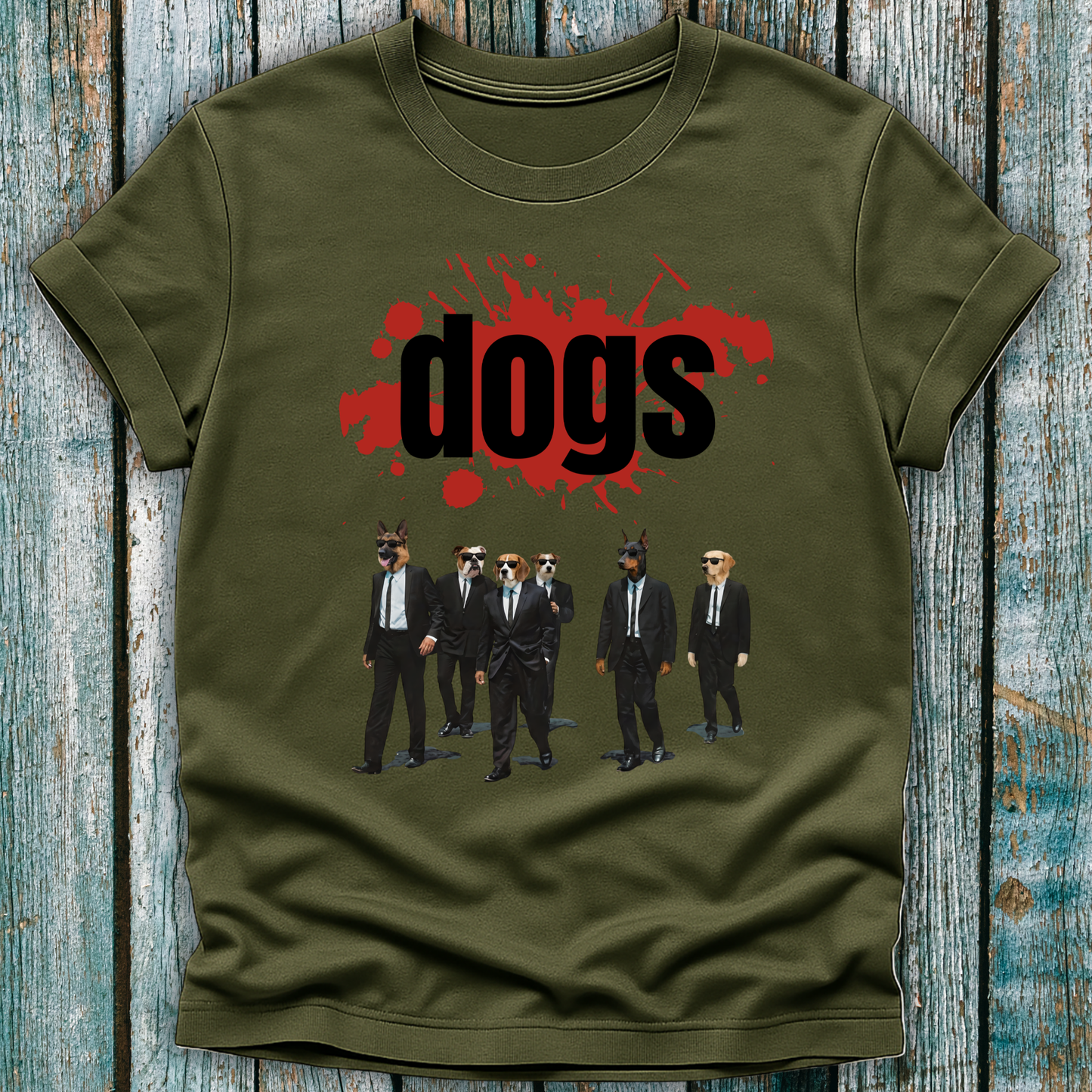 Green t-shirt with graphic design of dogs in suits and 'dogs' text on a wooden surface