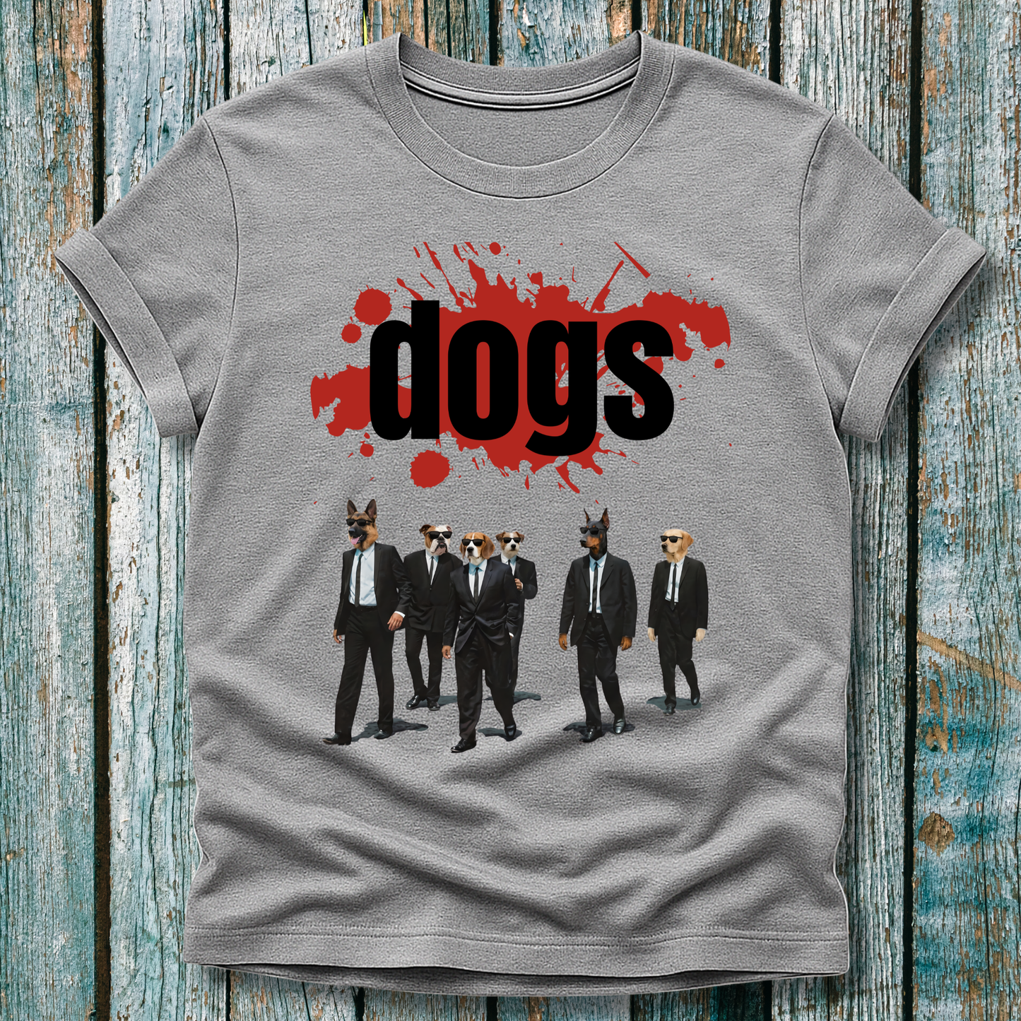 Gray t-shirt with graphic design of dogs in suits and 'dogs' text on a wooden surface