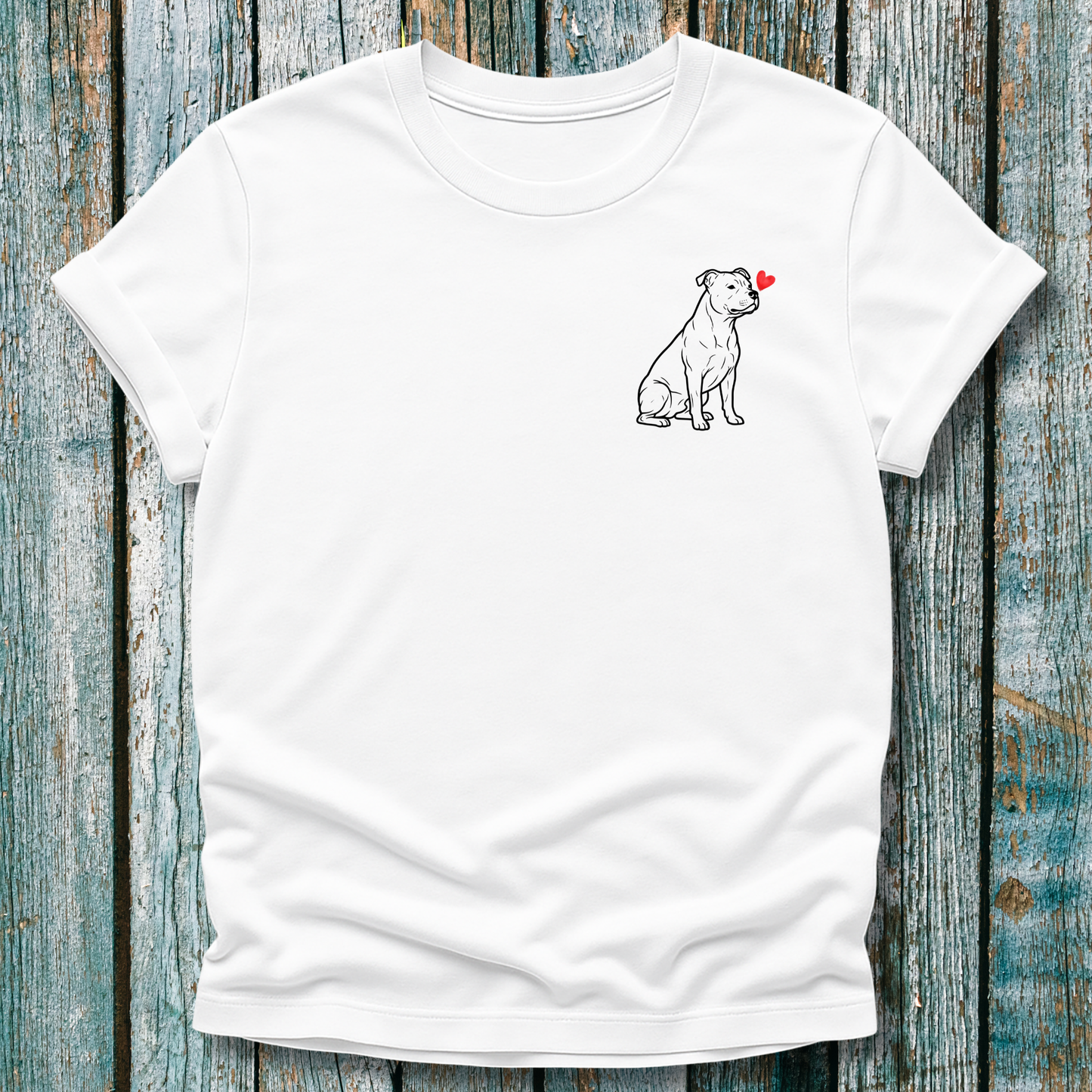 White  t-shirt with a Pibull dog graphic and love heart on a wooden surface