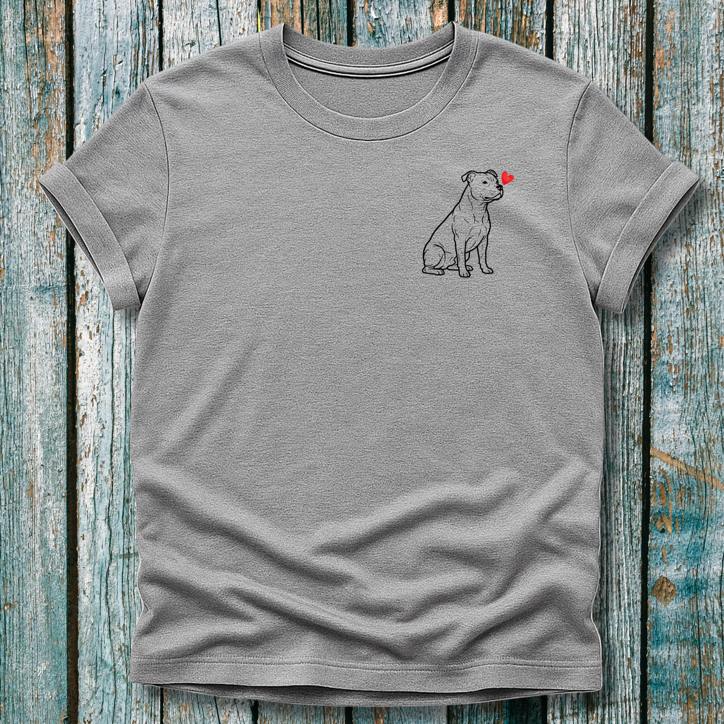 Gray  t-shirt with a Pibull dog graphic and love heart on a wooden surface