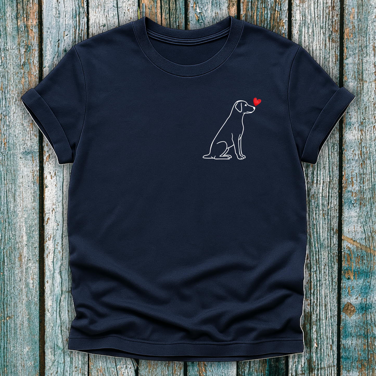 Navy blue t-shirt with a Labrador dog graphic and red heart on a wooden surface