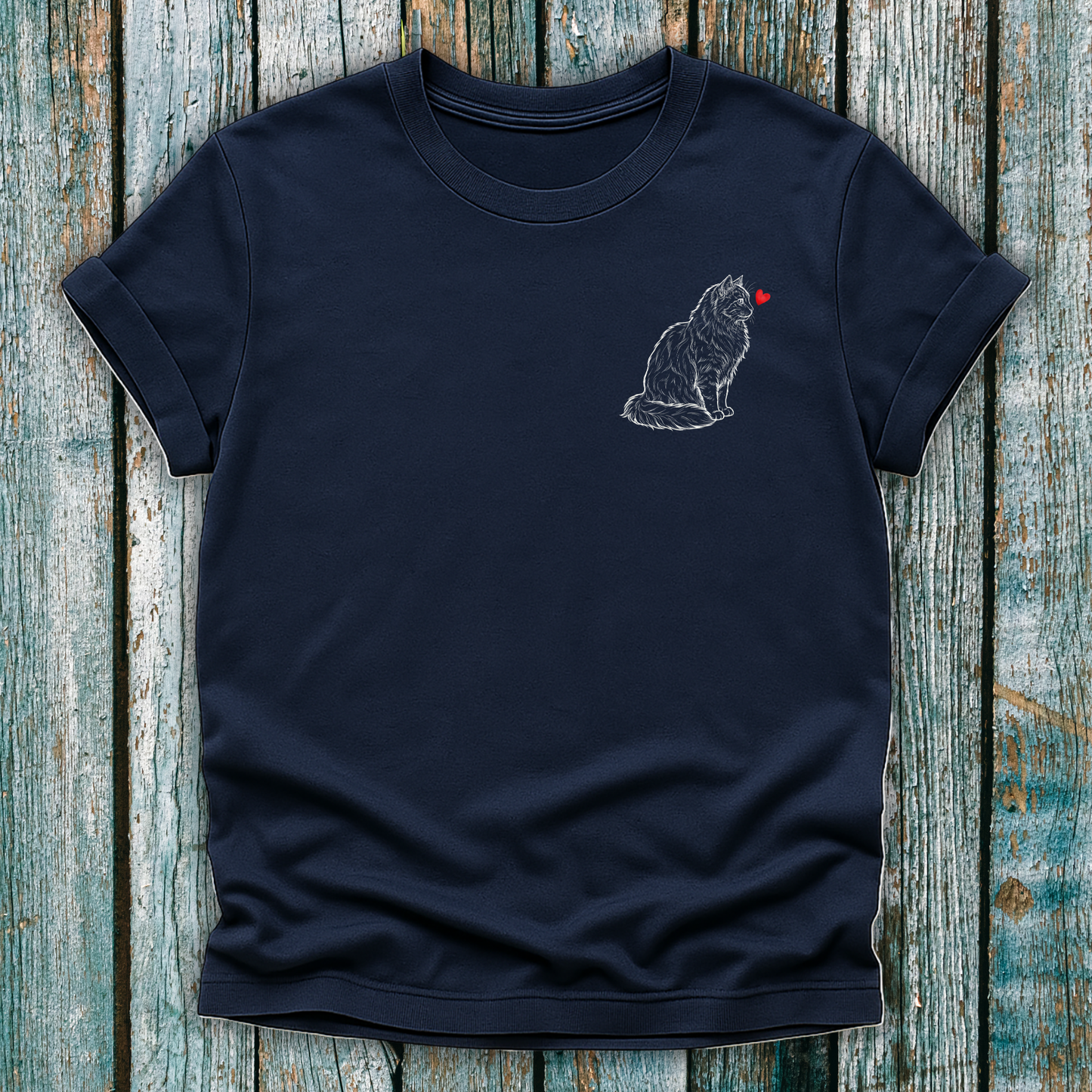 Navy blue  t-shirt with a cat graphic and red heart on a wooden surface