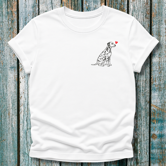 White t-shirt with a Dalmatian dog illustration and a red heart on a wooden surface