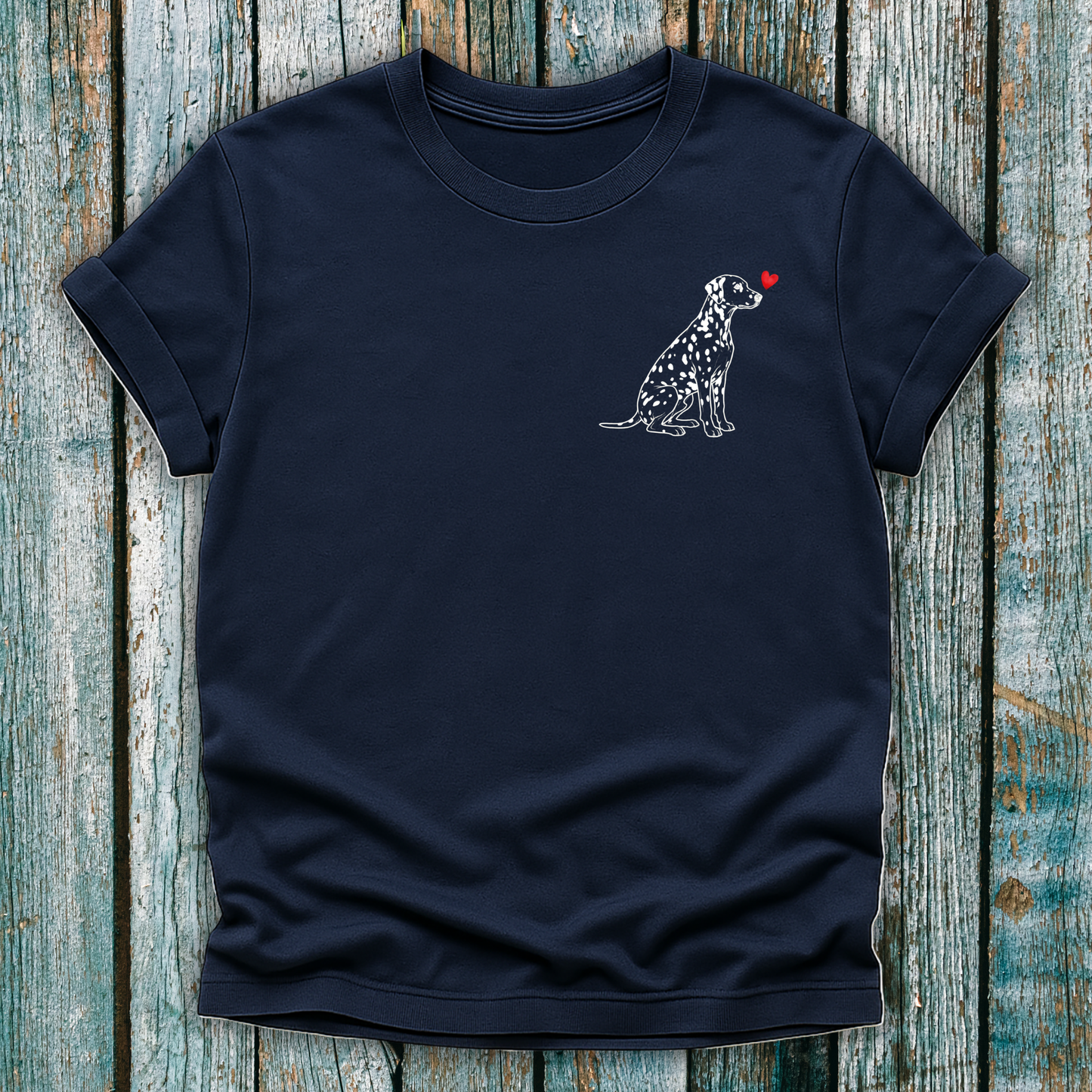 Navy bue t-shirt with a Dalmatian dog illustration and a red heart on a wooden surface