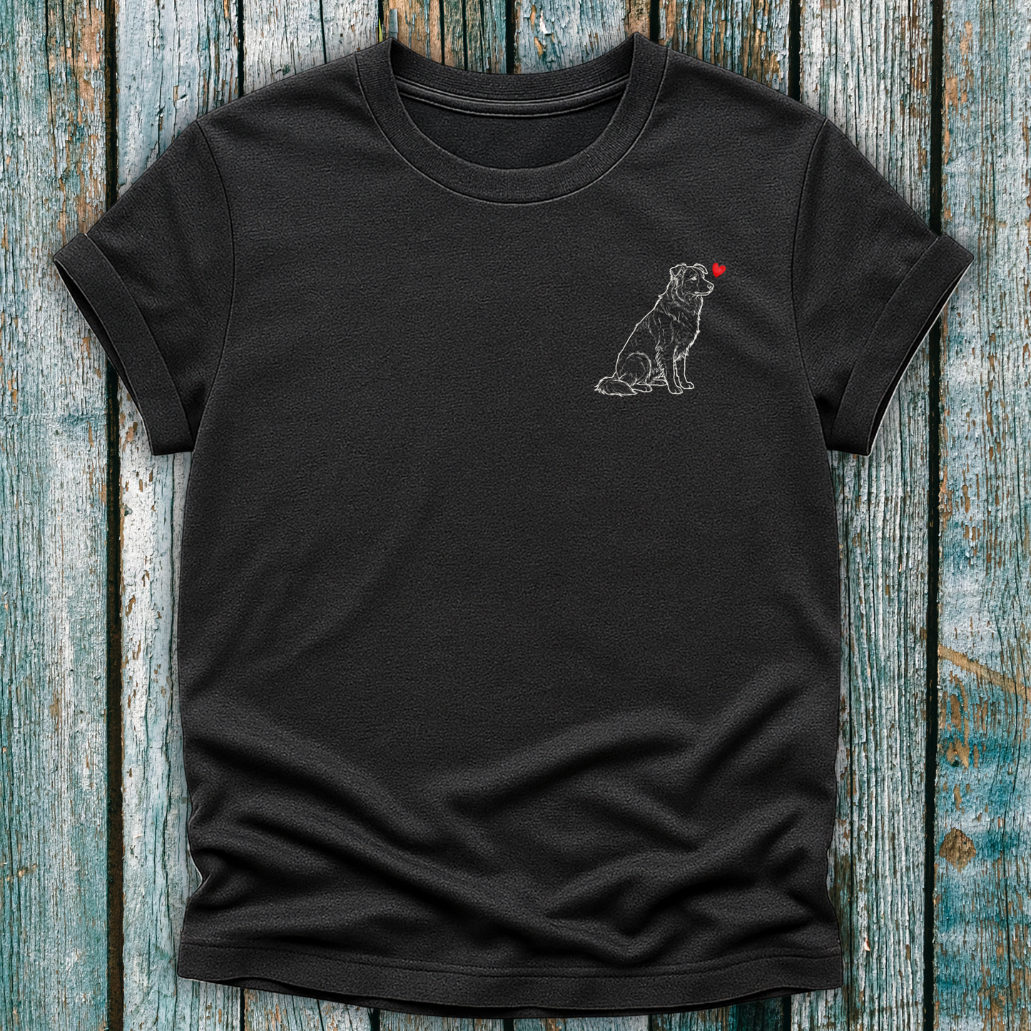 Dark Gray t-shirt with a Greyhound dog graphic and a red heart on a wooden surface
