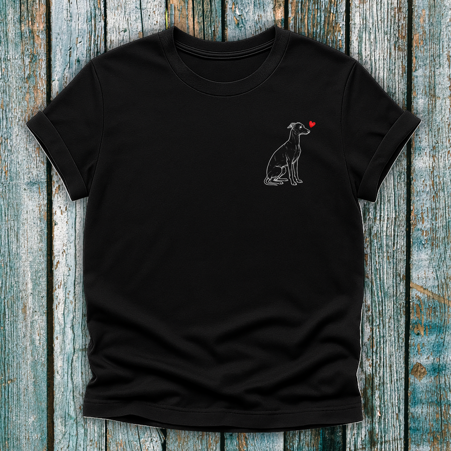Black t-shirt with a Greyhound dog graphic and red heart on a wooden surface