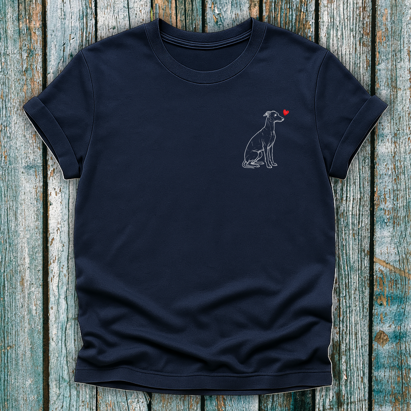 Navy blue t-shirt with a Greyhound dog graphic and red heart on a wooden surface