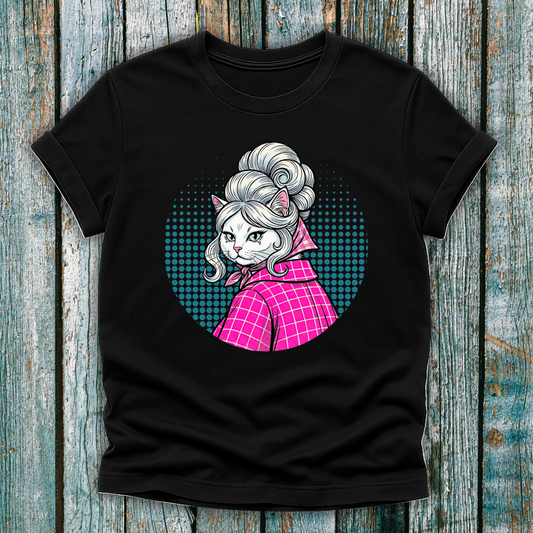 Black t-shirt with a colorful graphic of a pop art cat character in a pink outfit on a wooden surface