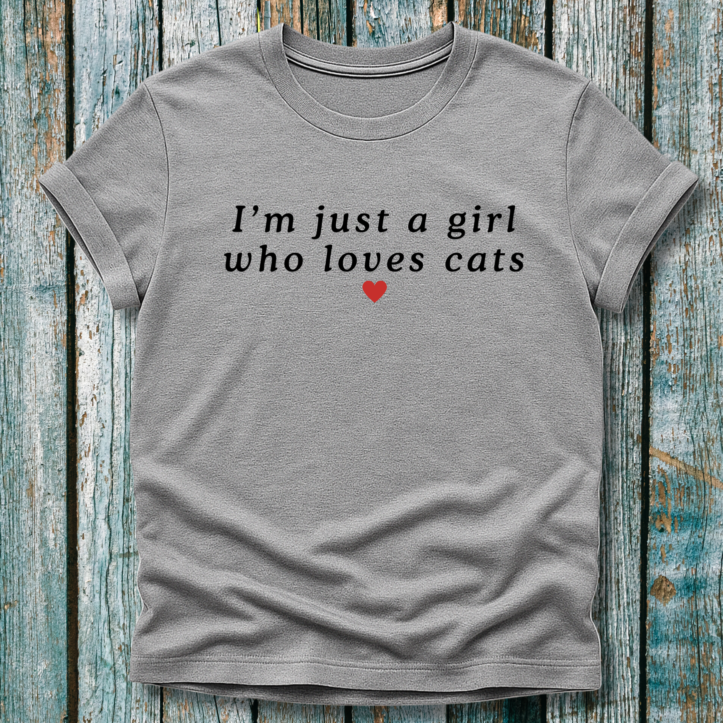 Gray t-shirt with text 'I'm just a girl who loves cats' on a wooden background