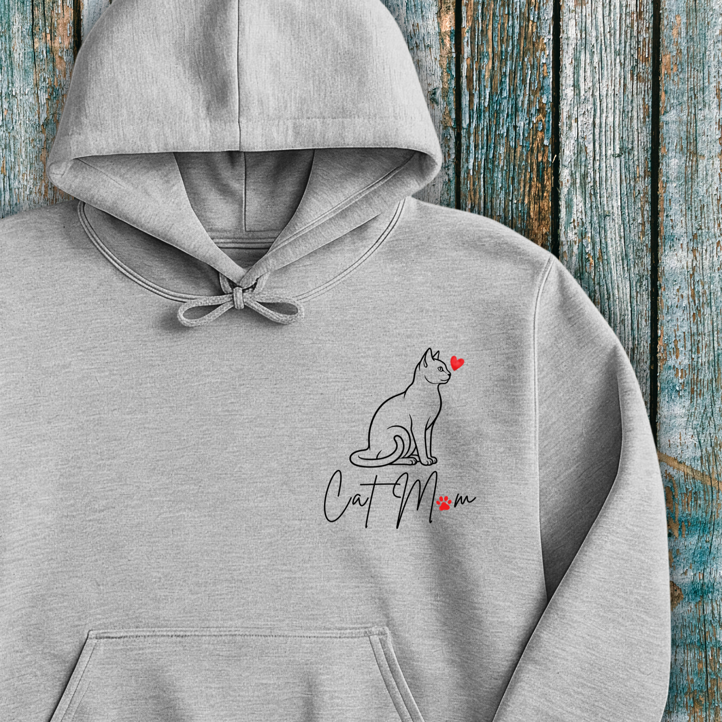 Gray hoodie with 'Cat Mom' graphic and red heart on a wooden background