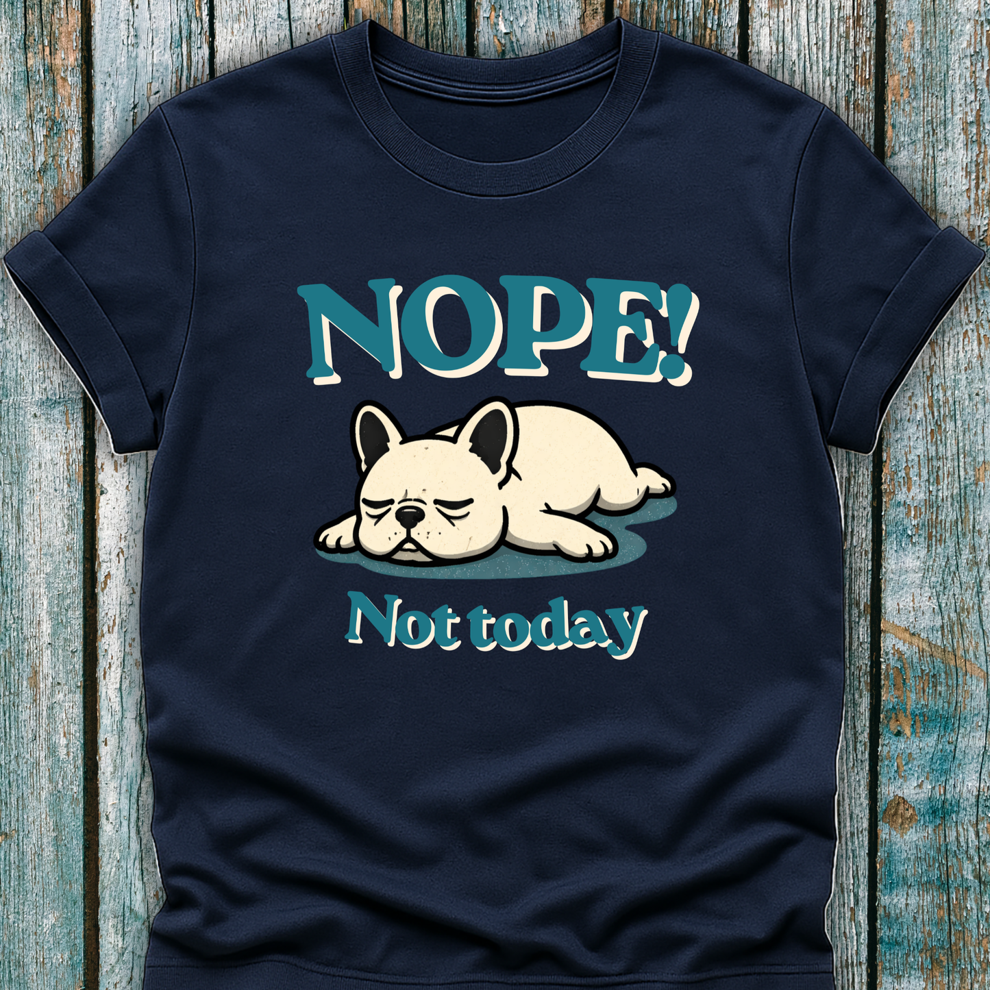 Navy blue t-shirt with a dog graphic and text 'NOPE! Not today' on a wooden surface