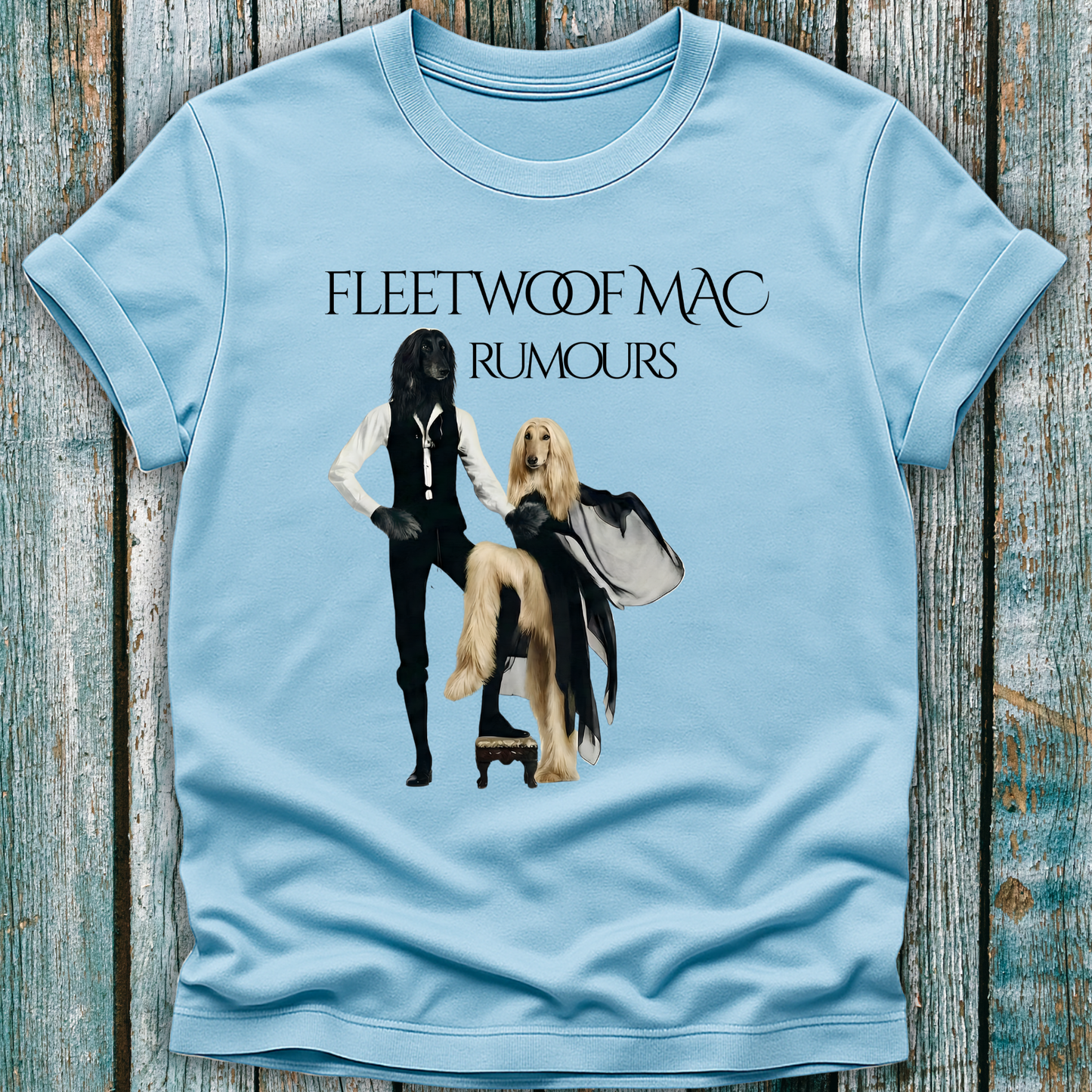 Light blue t-shirt with Fleetwoof Mac 'Rumours' design on a wooden surface