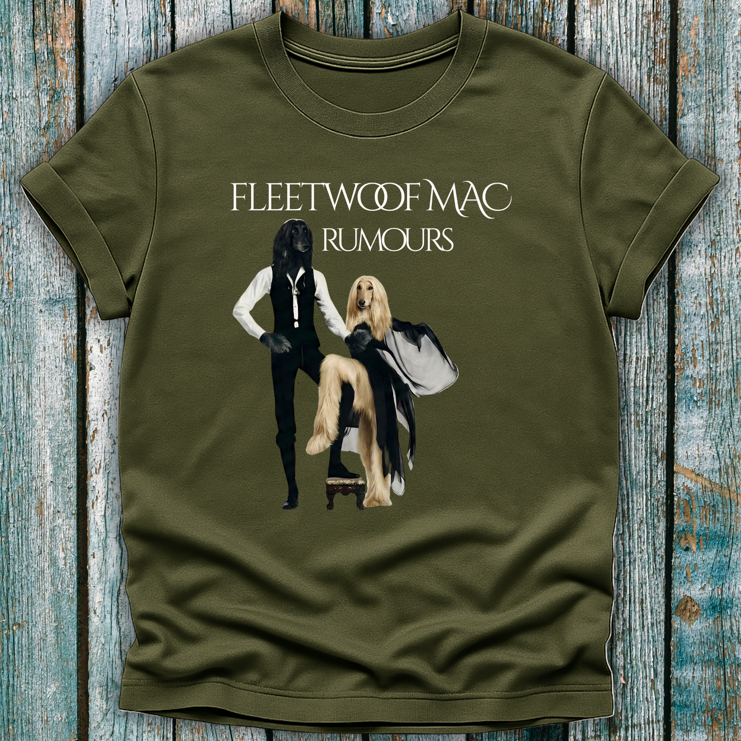 Green t-shirt with Fleetwoof Mac album cover design on a wooden surface