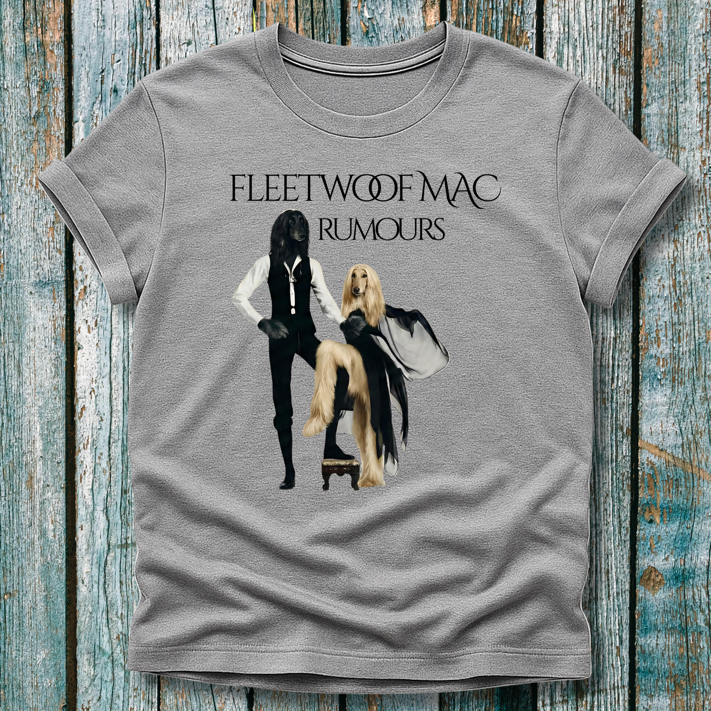 Gray t-shirt with Fleetwoof Mac 'Rumours' album cover design on a wooden surface