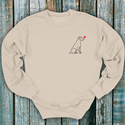 Beige sweatshirt with a Labrador dog and heart design on a wooden surface
