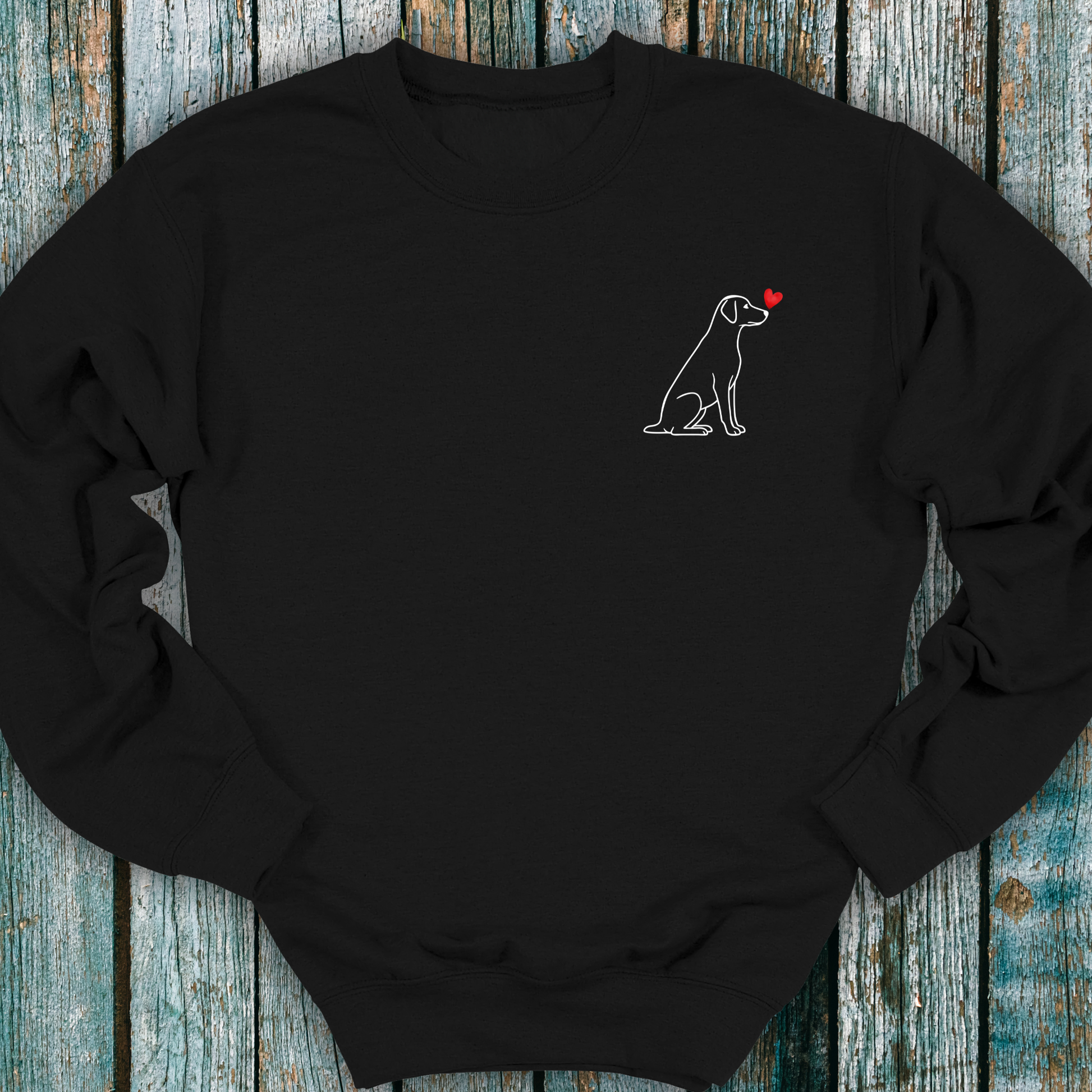 Black sweatshirt with a Labrador dog and heart design on a wooden surface