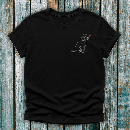 Black t-shirt with a Cavapoo dog and heart design on a wooden surface