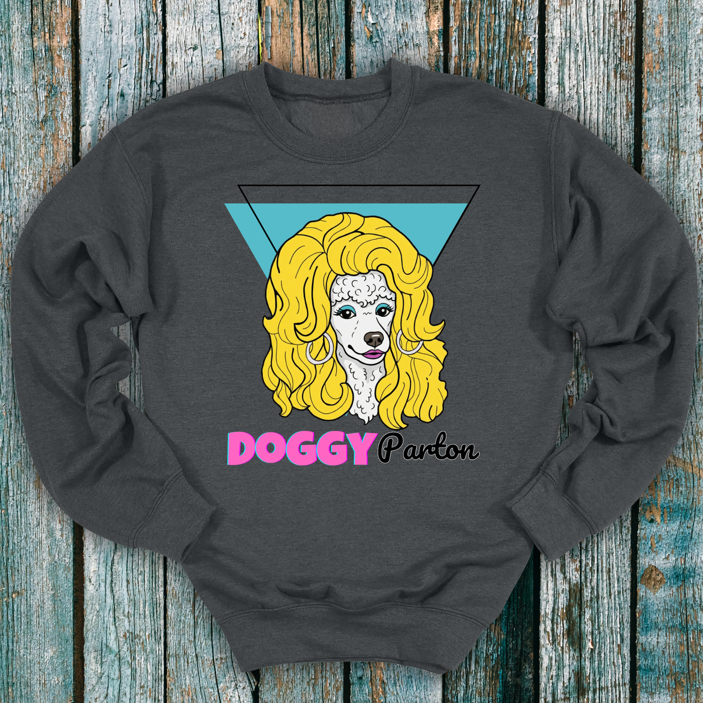 Gray sweatshirt with a graphic of a dog with blonde hair and the text 'Doggy Parton' on a wooden background
